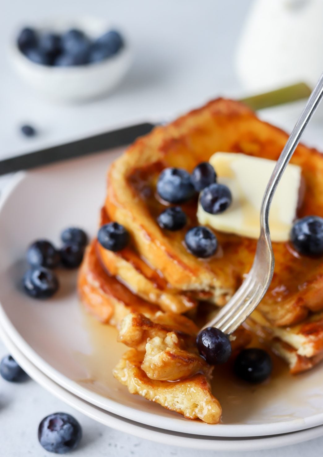 fork taking piece of French toast