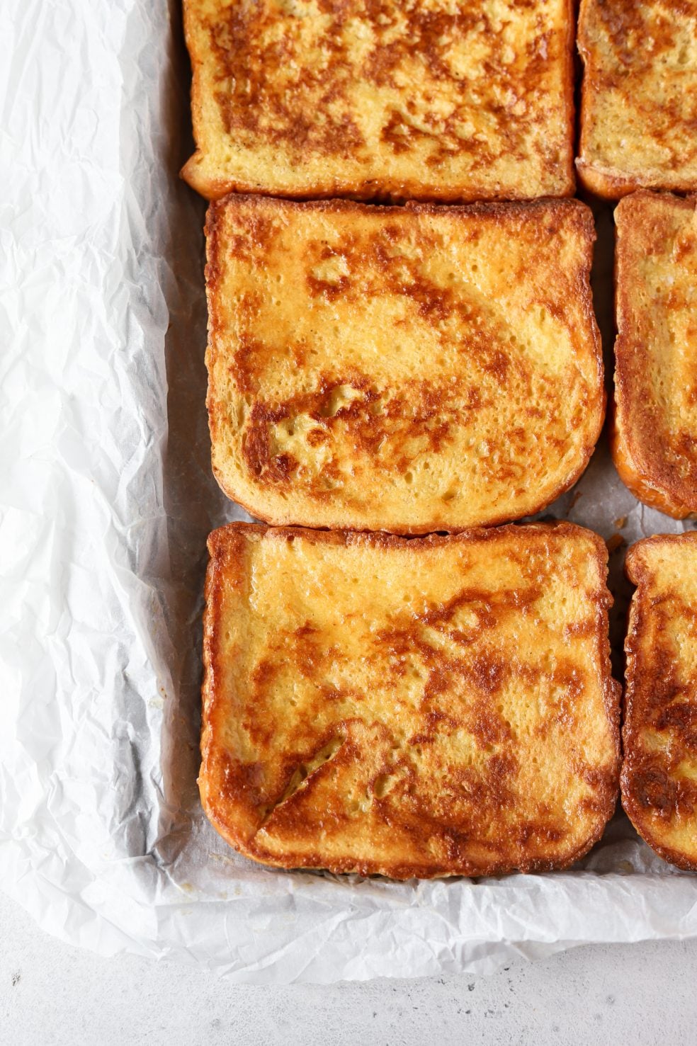 cooked French toast slices on parchment paper