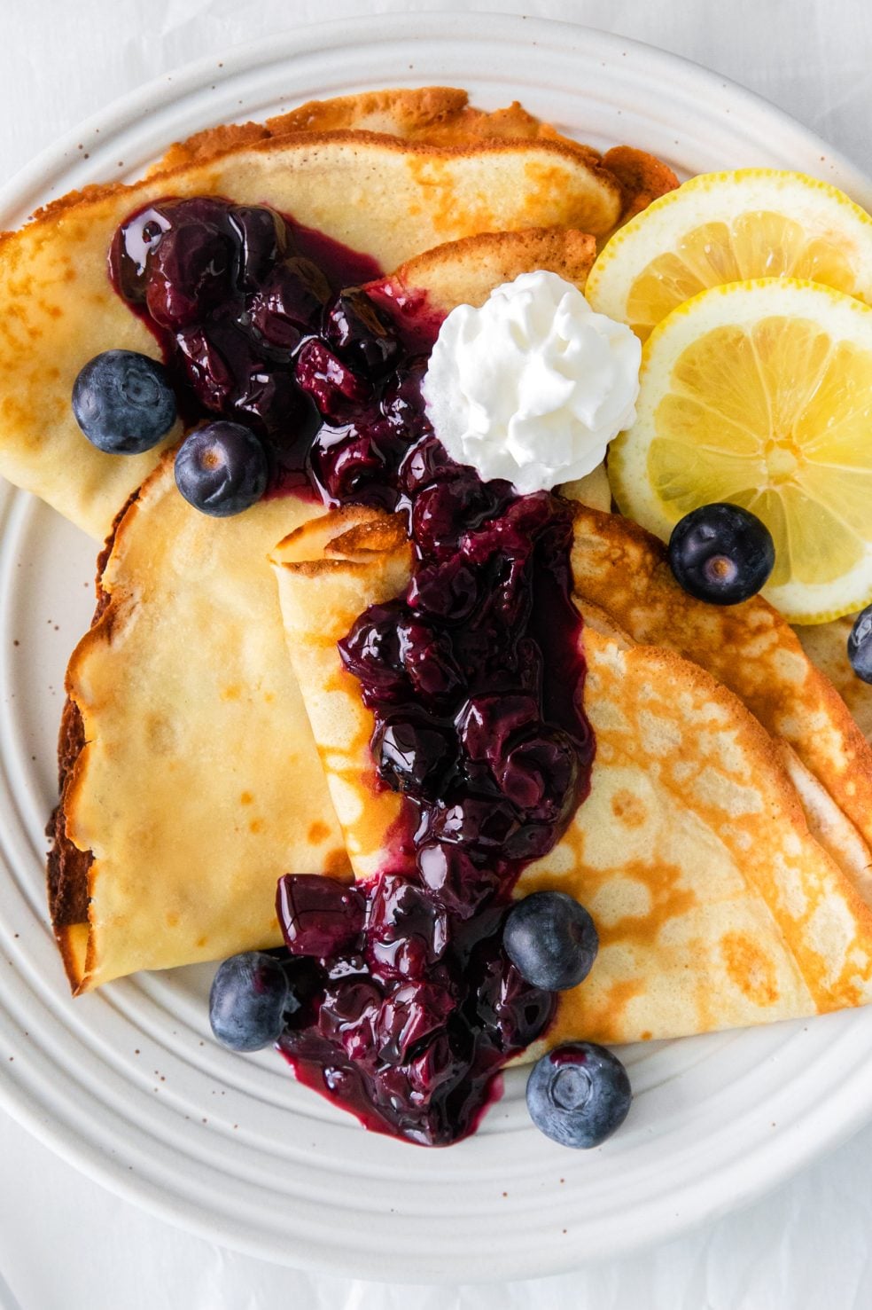 thin golden crepes topped with blueberry compote