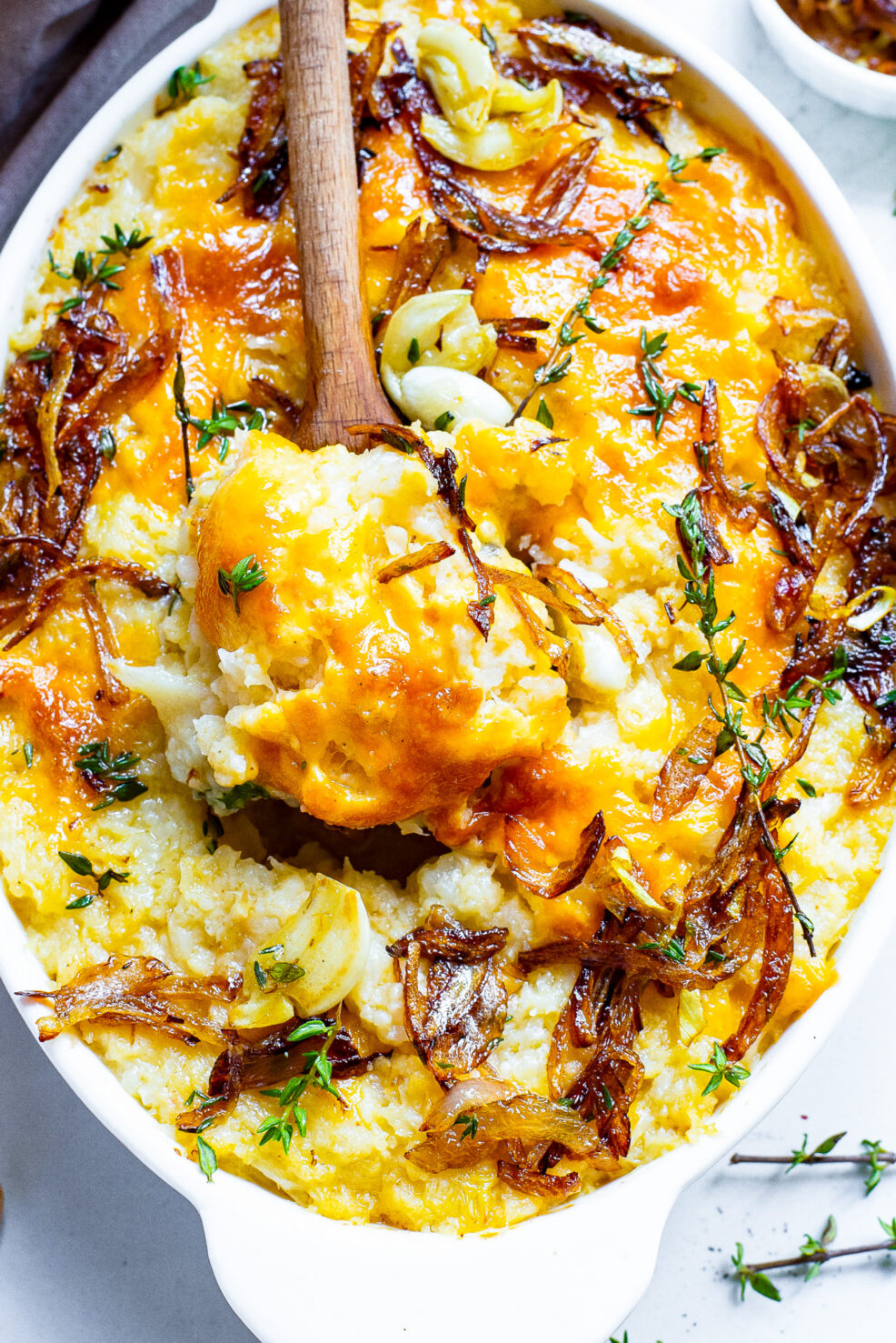 cauliflower mash in dish with serving spoon