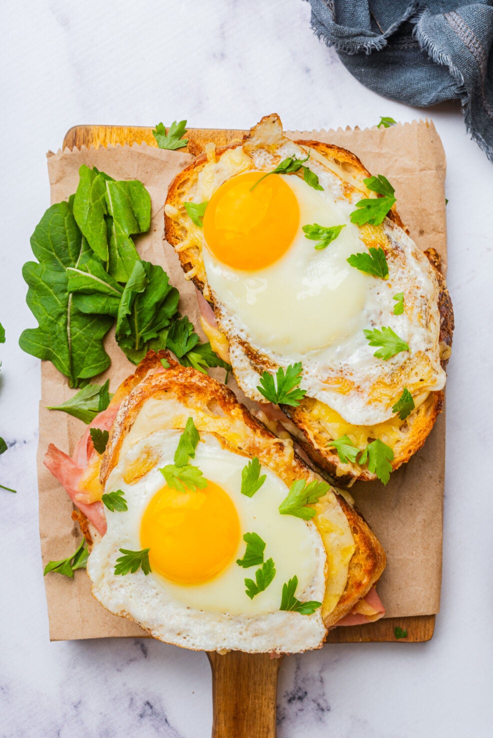 two prepared sandwiches on cutting board