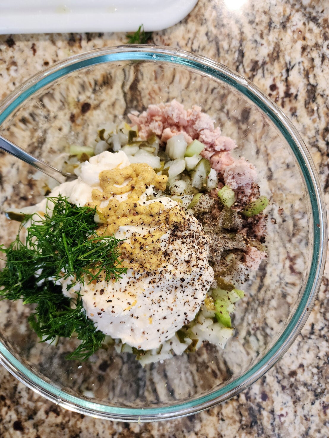 tuna salad ingredients in glass bowl