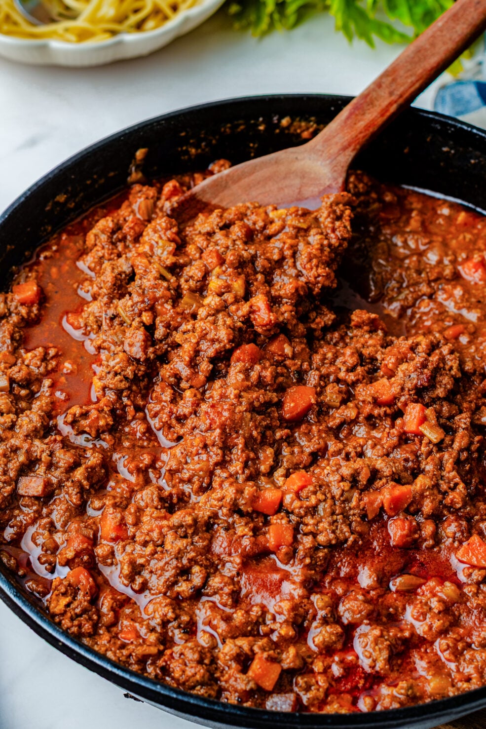 prepared sauce in pan with wooden spoon
